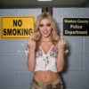 Blonde Rebel Flipping Off at Police Station